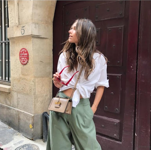 Candid street photography of a stylish woman, representing the high-quality travel and lifestyle photos you can showcase on a Picrora screen.