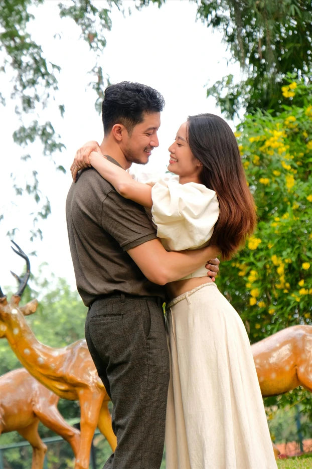 A happy couple hugging in nature, capturing a romantic moment perfect for displaying on a Picrora digital frame as an anniversary gift.